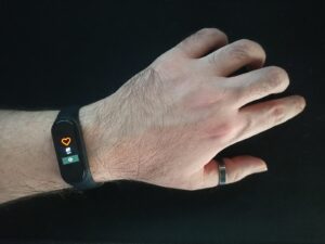 person wearing black and silver ring